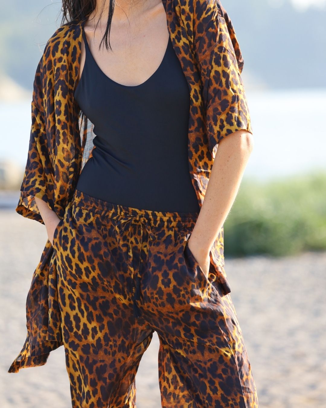 Person wearing a leopard print outfit with a blurred natural background